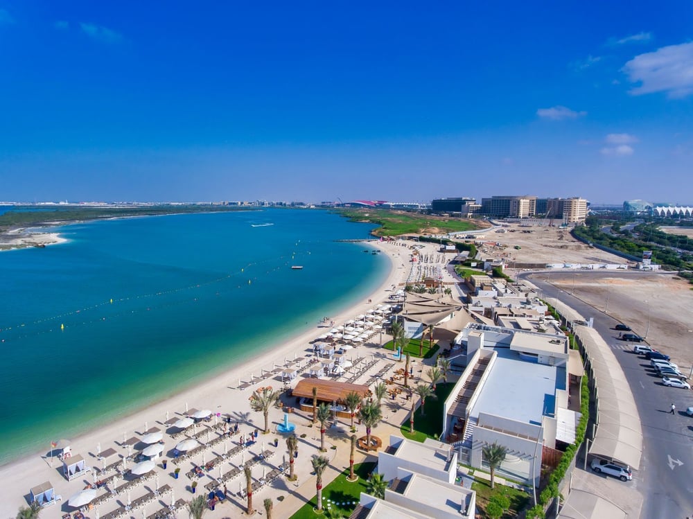 Aerial view of Yas Beach on Yas Island, Abu Dhabi, with turquoise water, white sand, and beachfront facilities